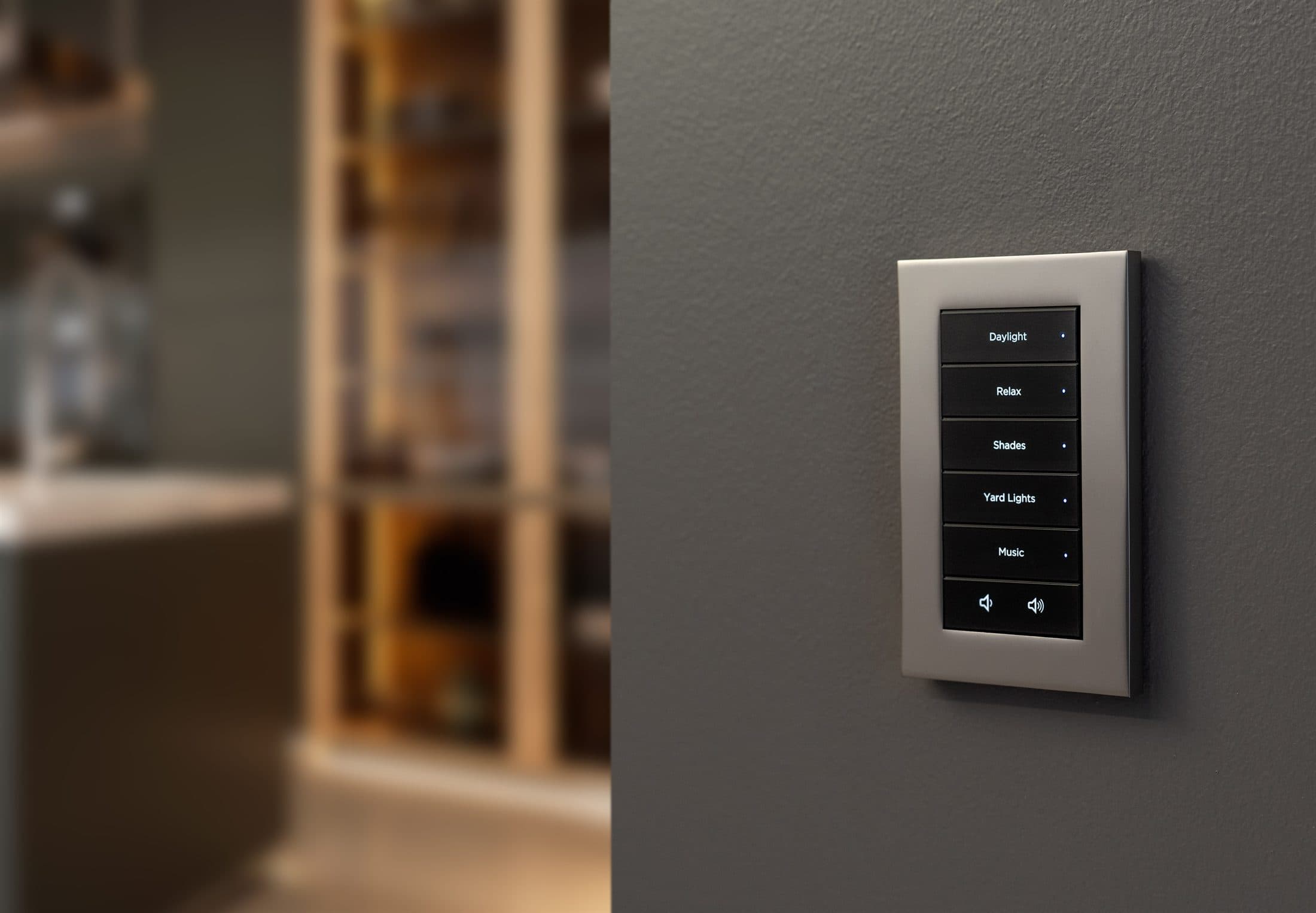 A satin-nickel Control4 keypad with backlit scene buttons in a softly lit luxury kitchen