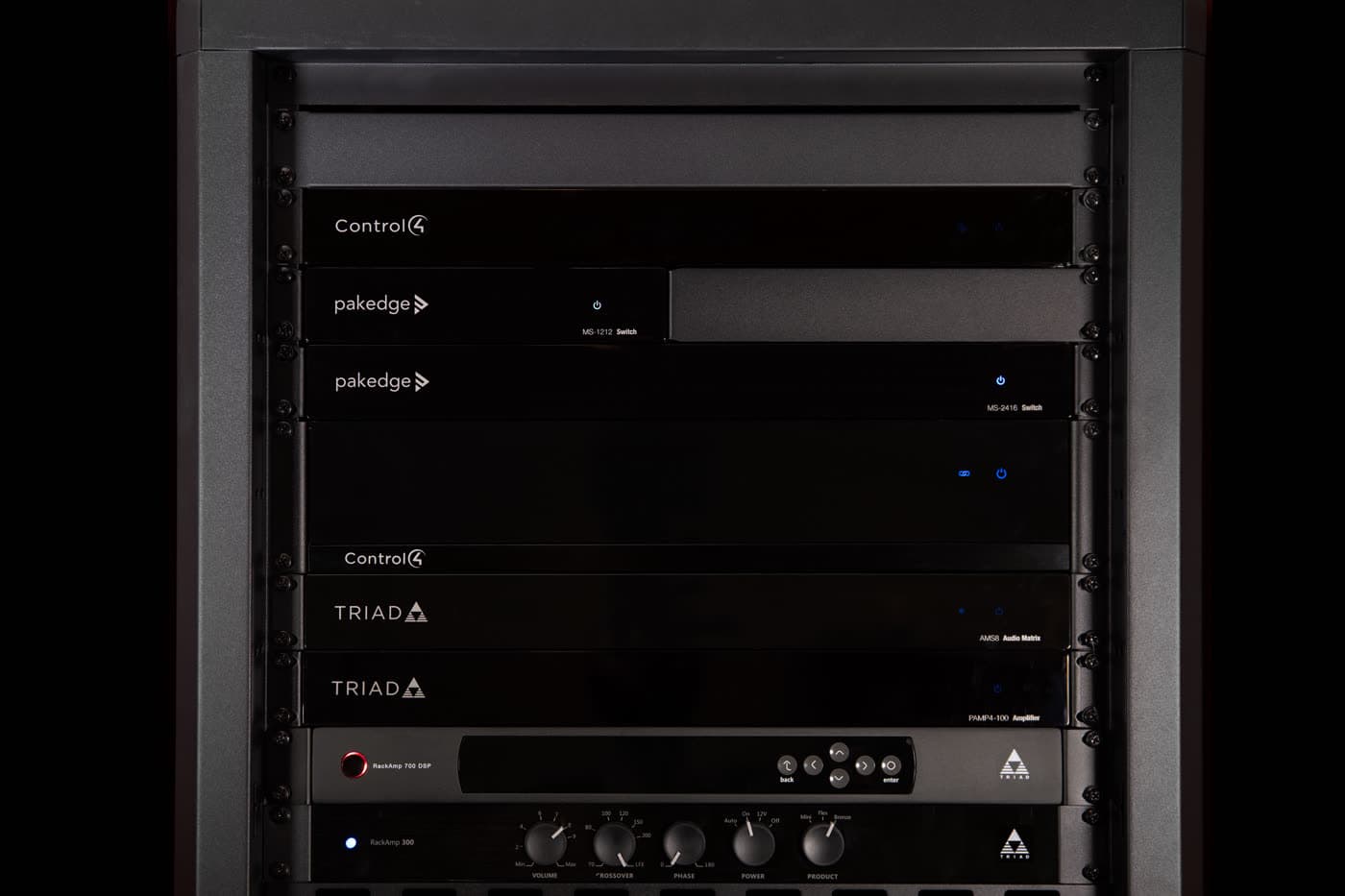 A neatly wired audio-visual equipment rack in a utility cupboard