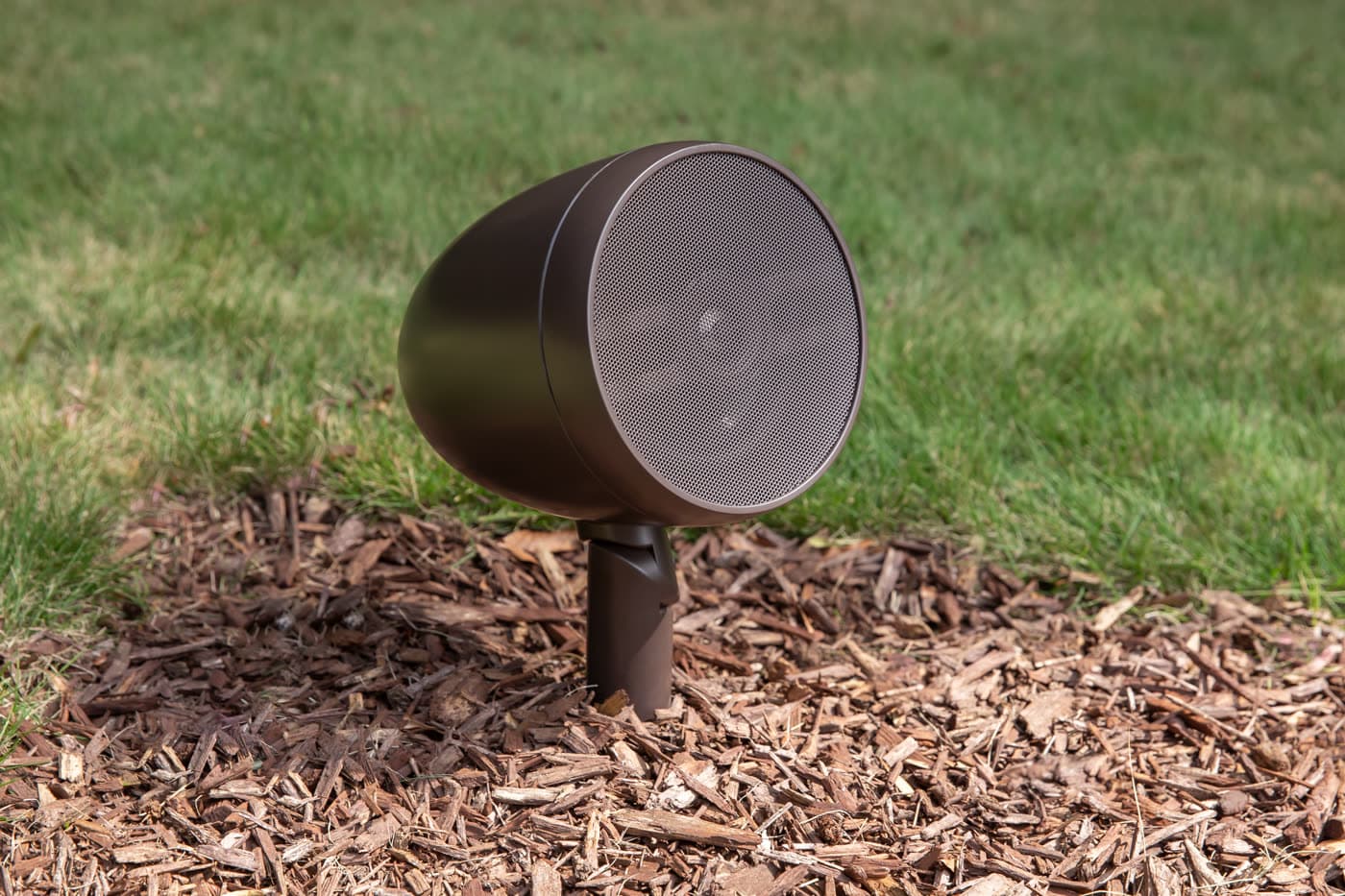 A discreet outdoor speaker set among garden planting